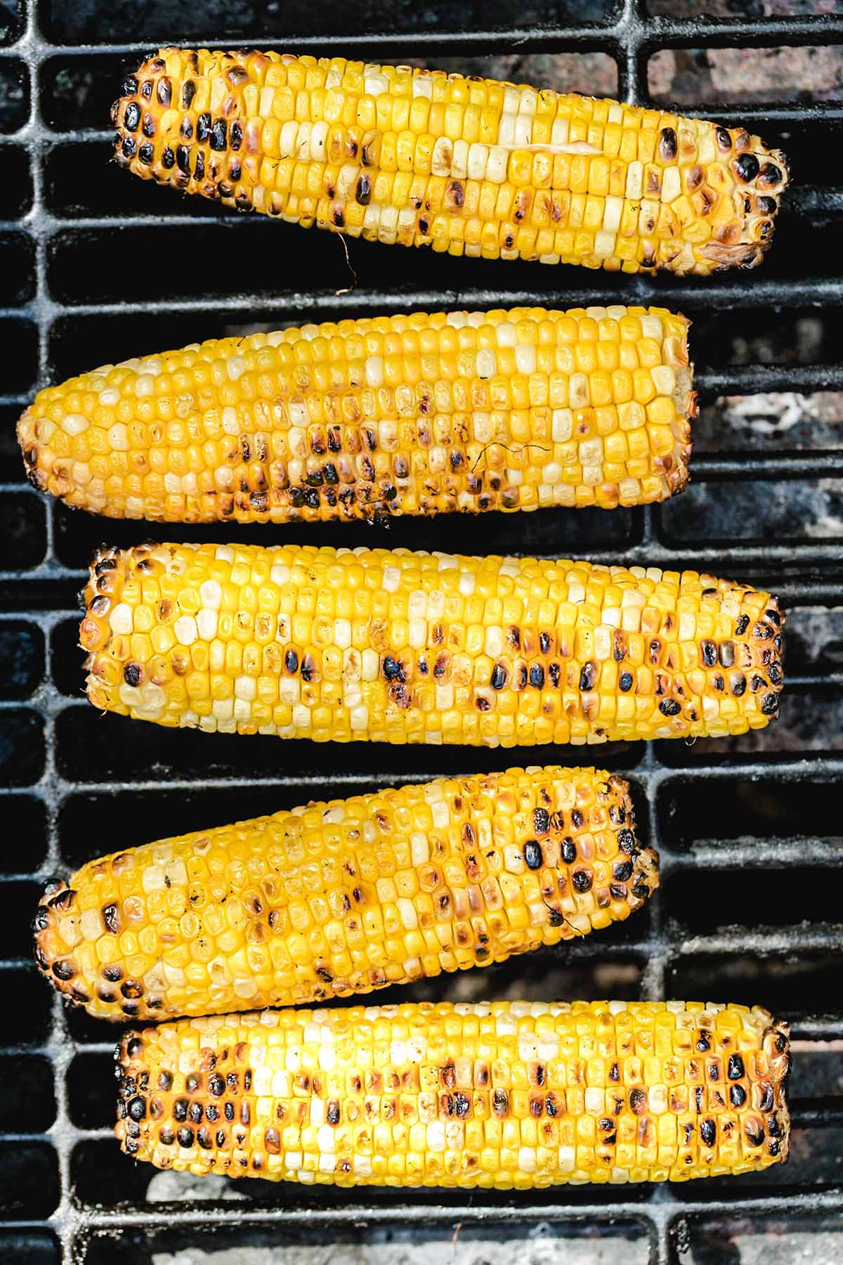 grilled corn on the cob on top of the grill. 