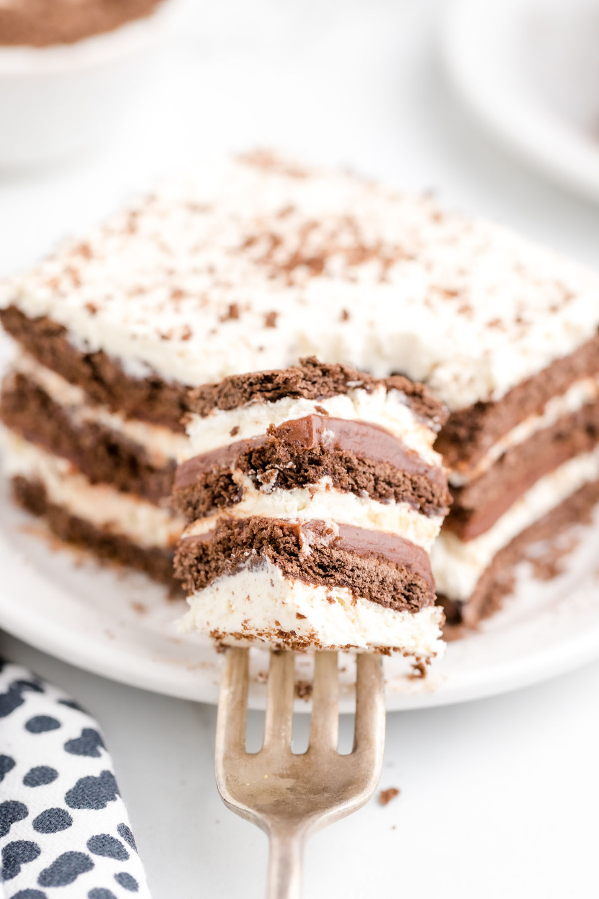 taking a piecenof Icebox Cake Chocolate Graham Crackers using a fork.