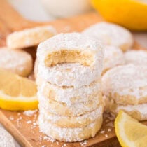 a stack of Lemon Cooler Cookies on a wooden board.