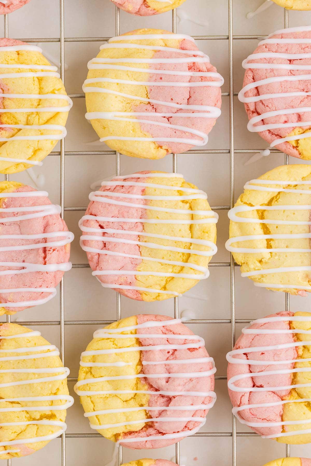 a couple of Strawberry Lemonade Cake Mix Cookies on a cooling rack.