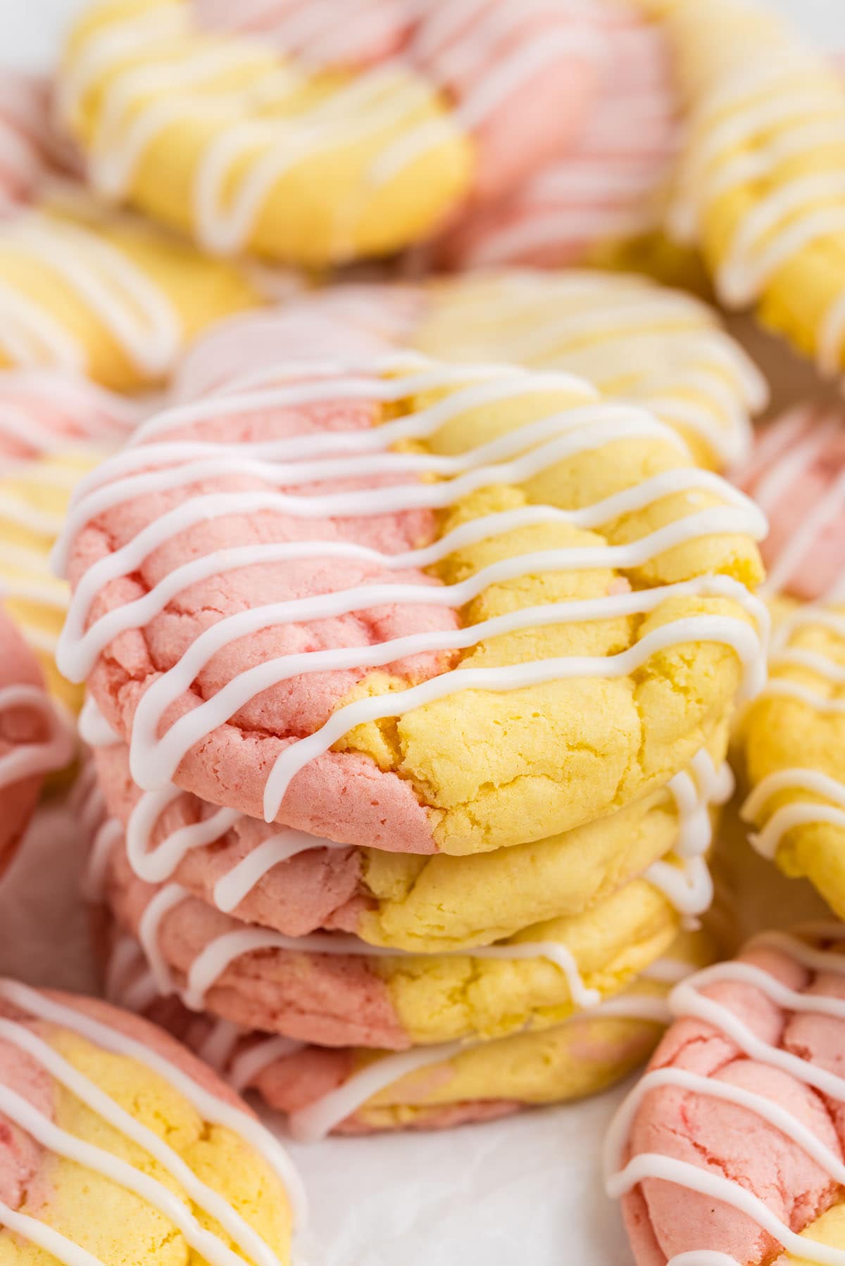 a stack of Strawberry Lemonade Cake Mix Cookies drizzled with white icing on top.