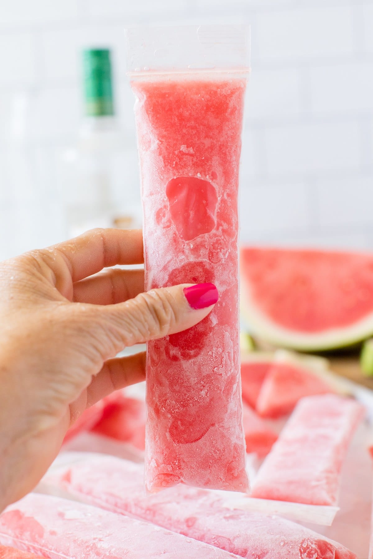 hand holding watermelon popsicle. 