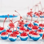 Patriotic cherry bombs dipped in white chocolate and blue sugar.