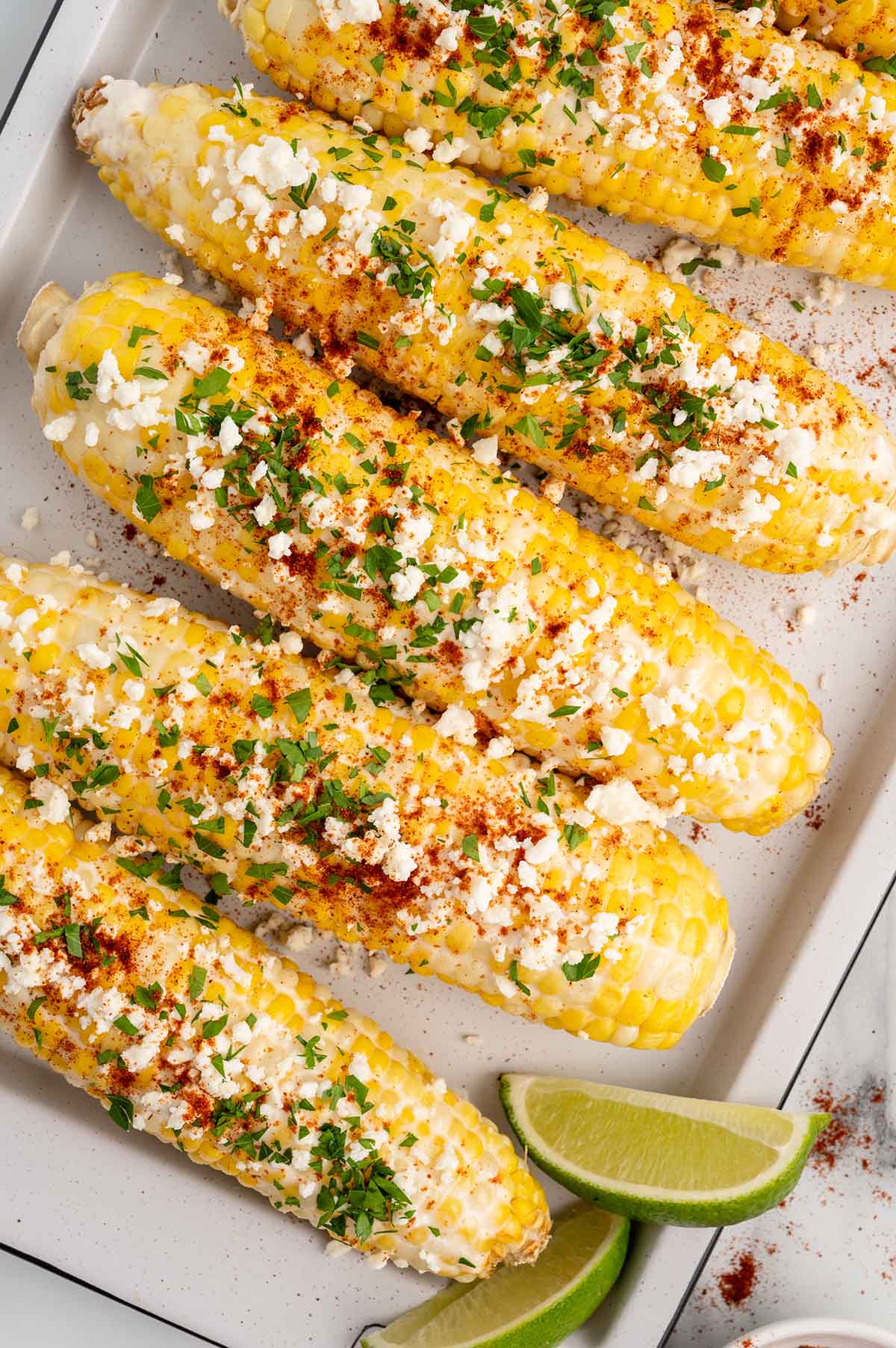 mexican corn with crema placed on the tray. 