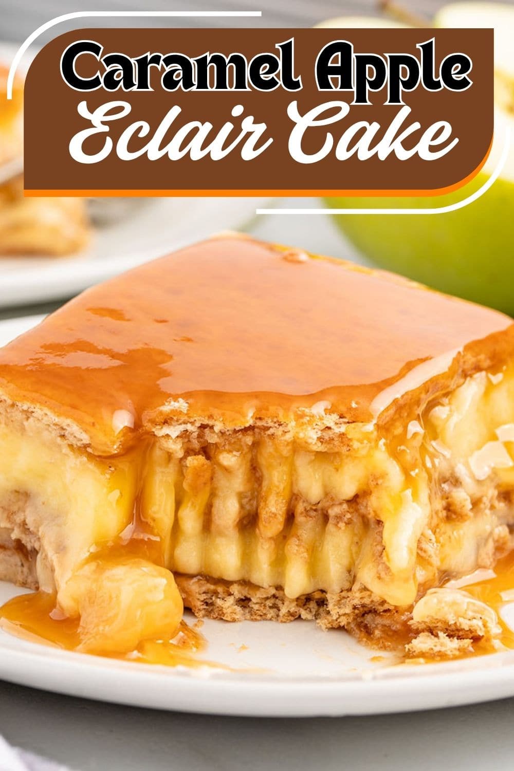 Caramel Apple Eclair Cake that has been cut, showing the layers inside with caramel drizzling from the top.