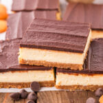 a couple of Cheesecake Bars on top of wooden board.