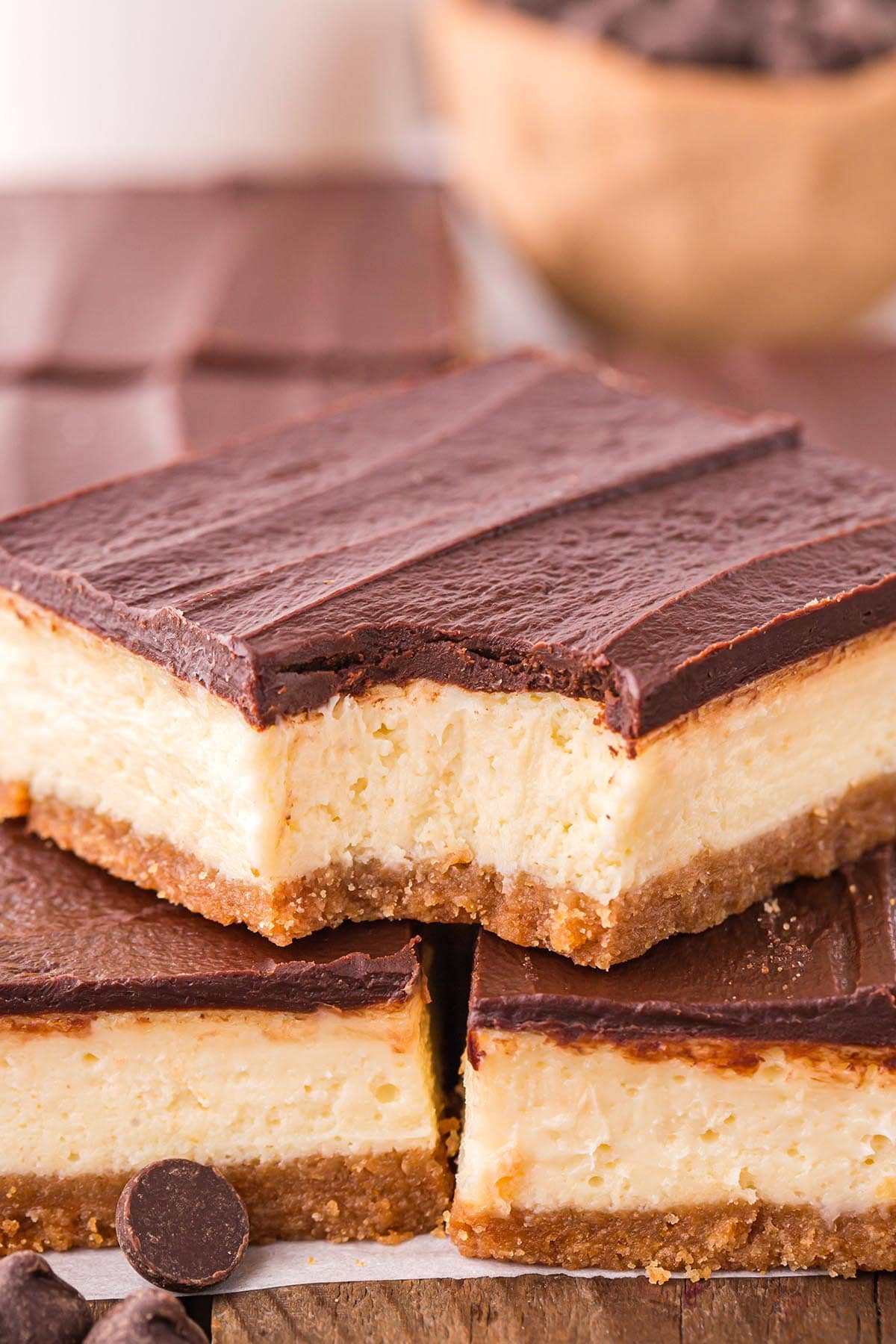 a Cheesecake Bars with a chocolate ganache layer on top.