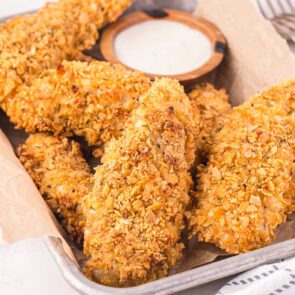 a couple of Cornflake Chicken in a square bowl.