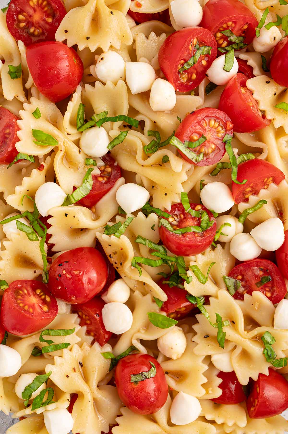 caprese pasta salad with mozzarella pearls. 