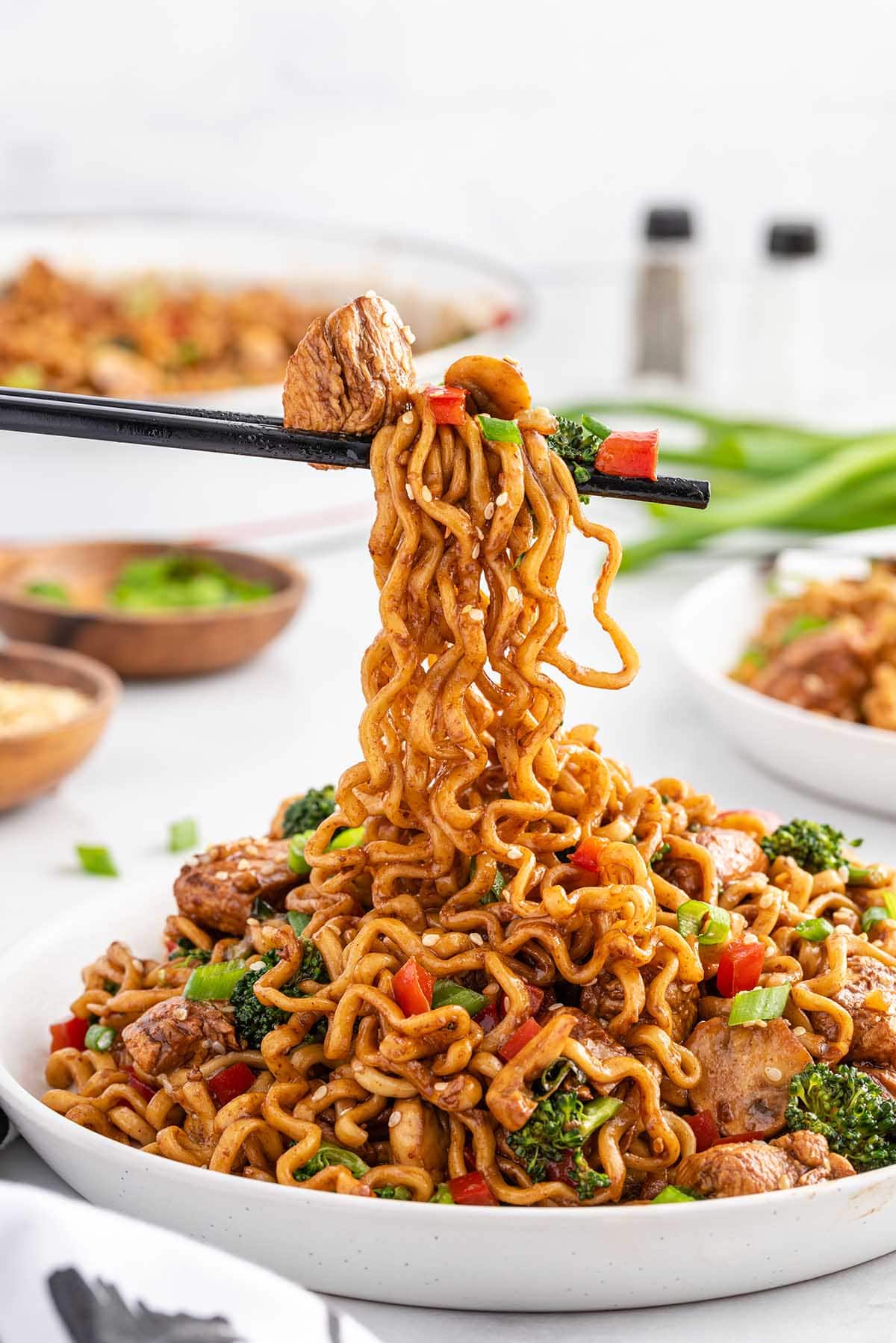 a bowl of Chicken Ramen Stir Fry with chopsticks.