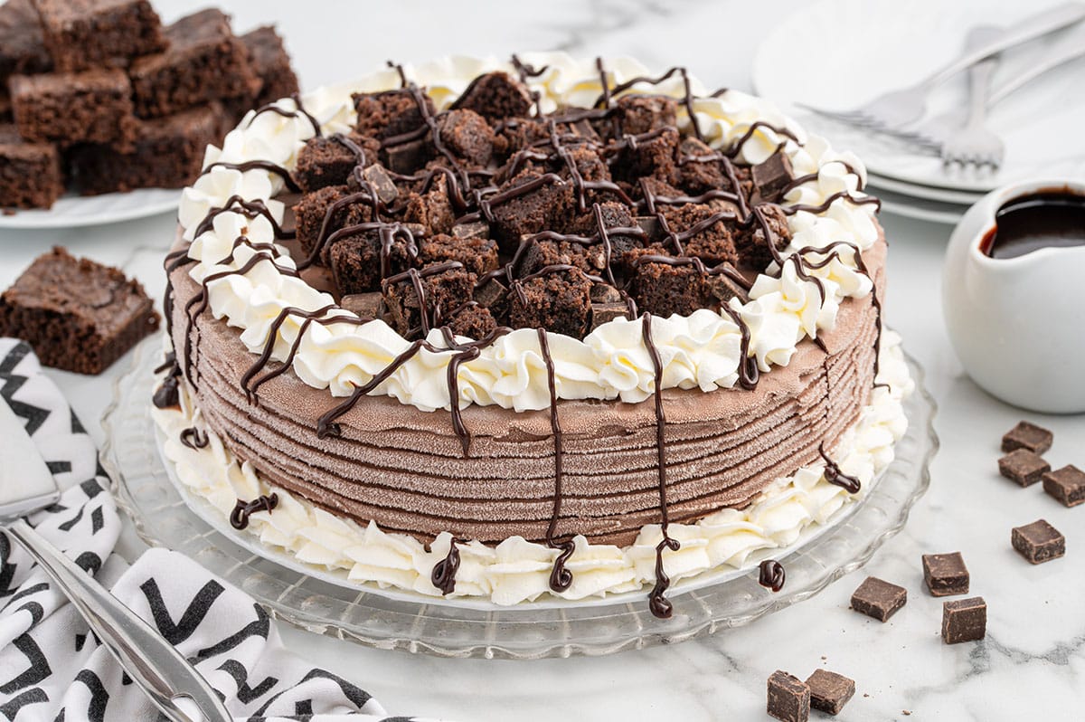 a Dairy Queen Copycat Chocolate Ice Cream Cake with whipped cream and chopped brownies on top.