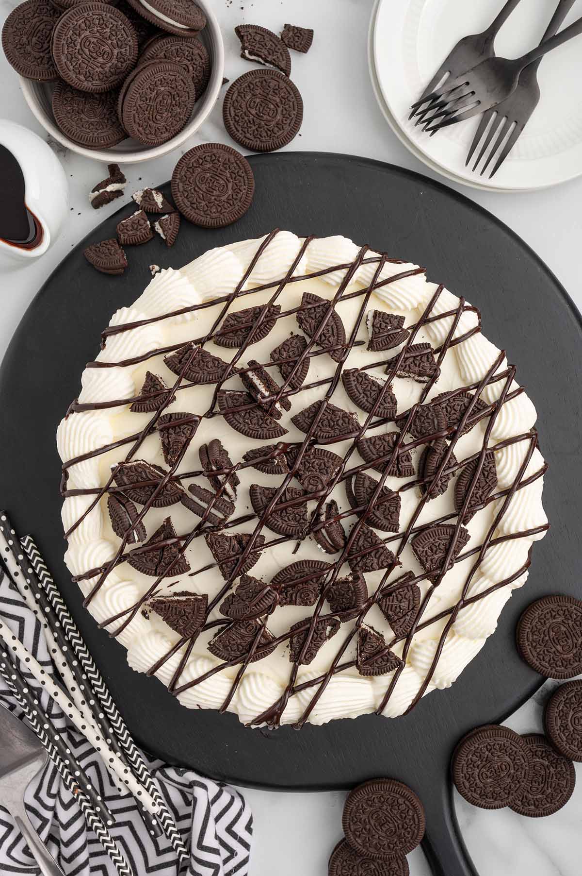 Dairy Queen Copycat Oreo Cookie Ice Cream Cake with chopped oreo and chocolate syrup on top.