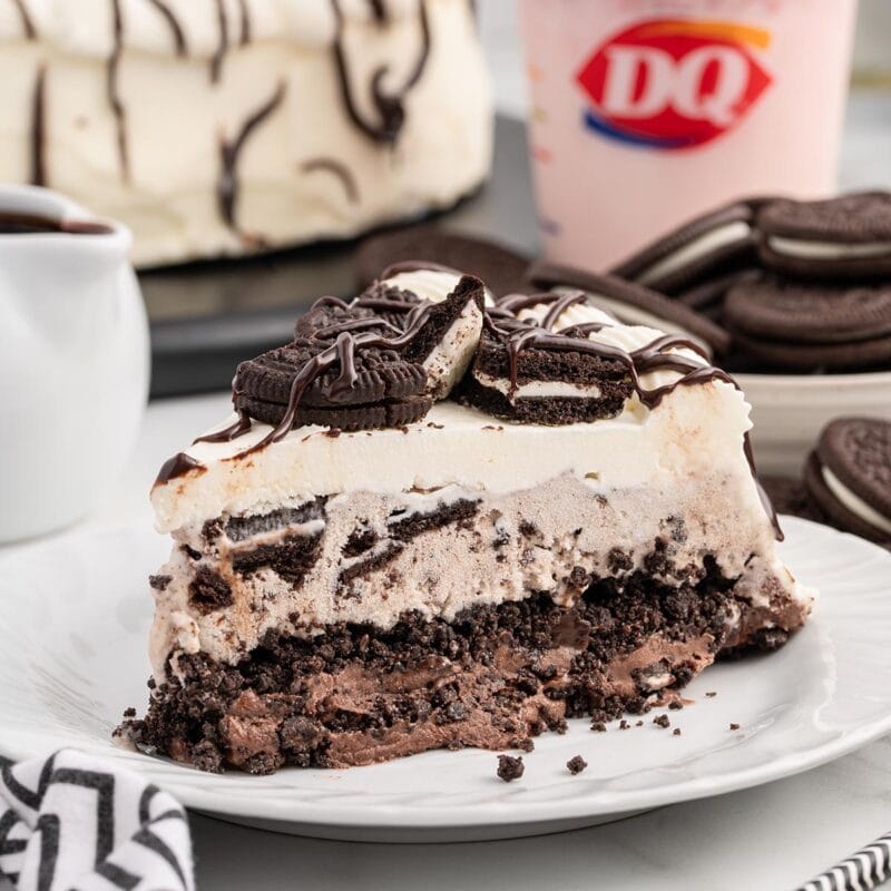 a slice of Dairy Queen Copycat Oreo Cookie Ice Cream Cake on a white plate.