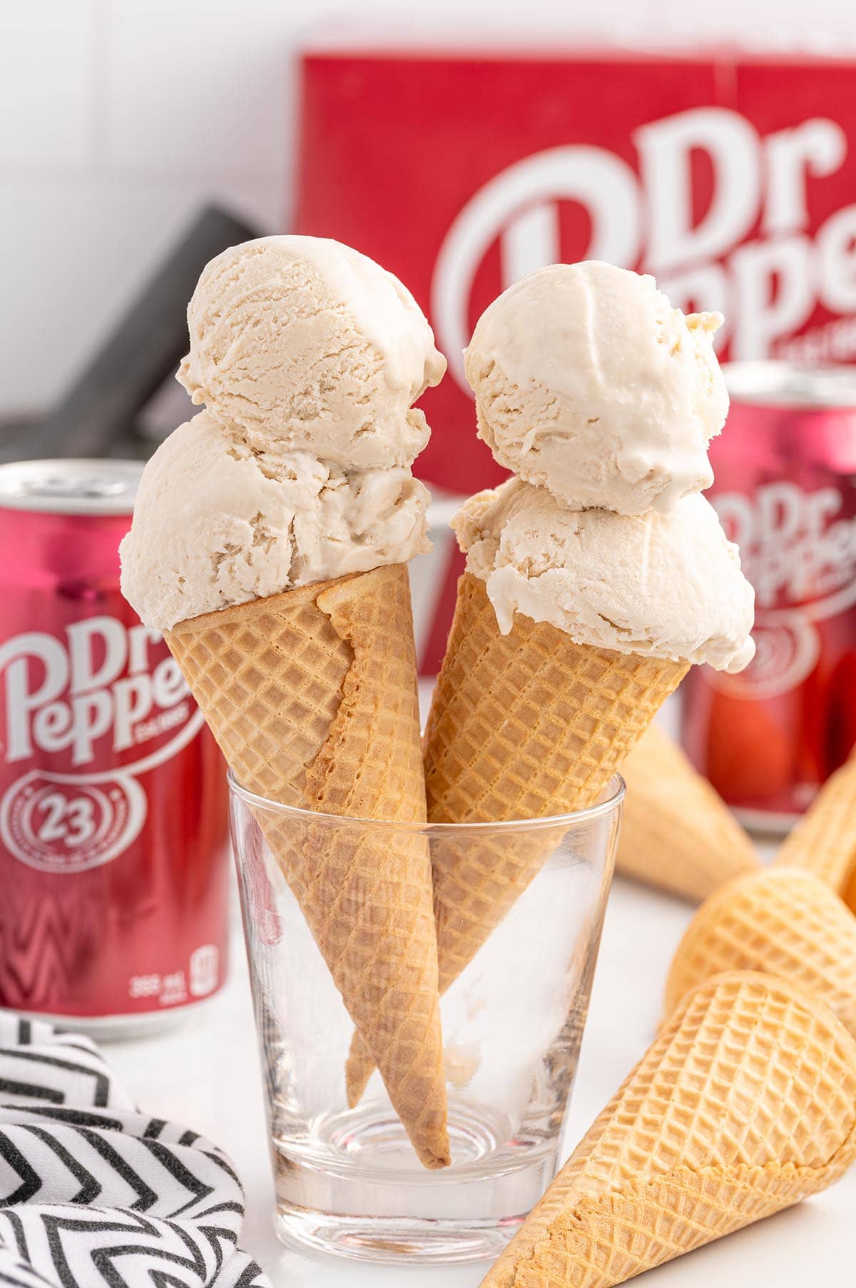 two waffle cones with scoops of Dr Pepper Ice Cream placed in a glass.