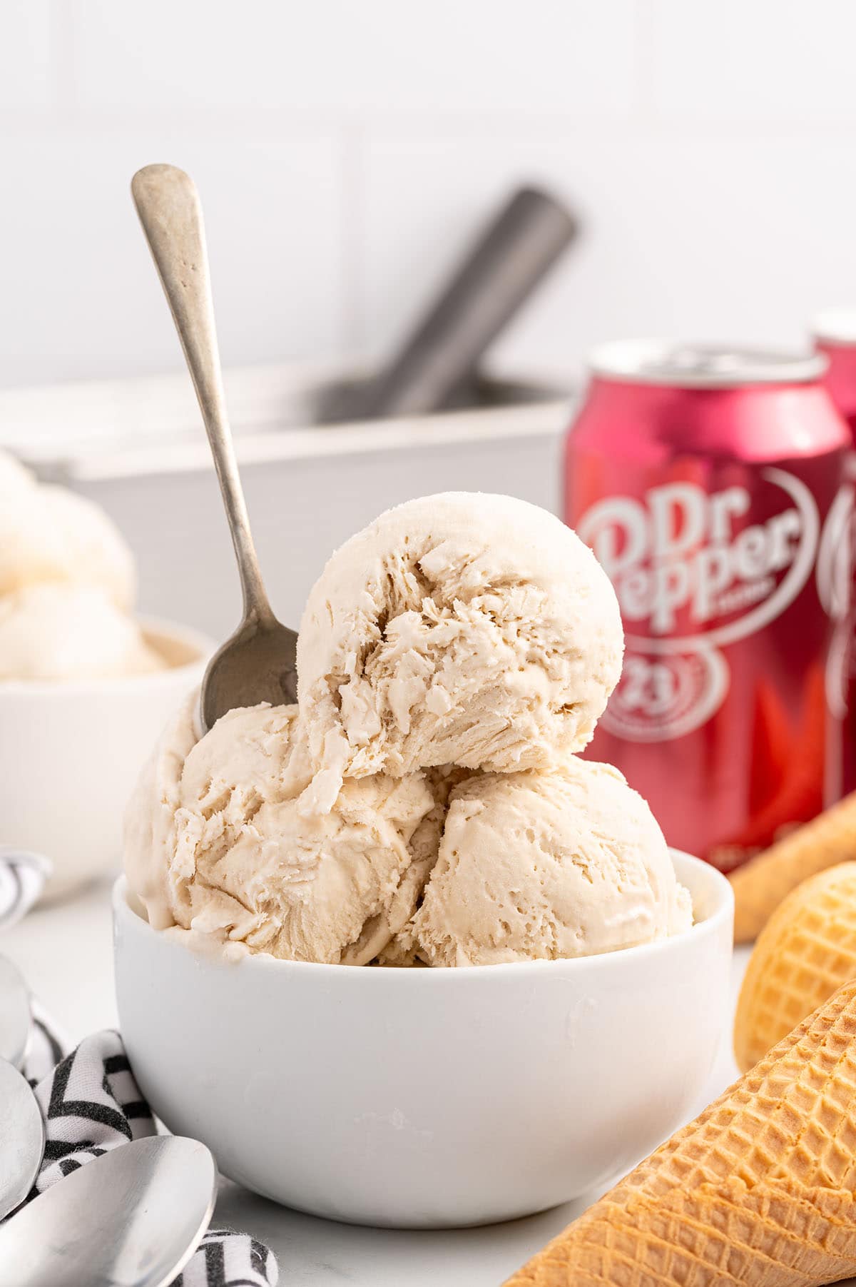 a bowl Dr Pepper Ice Cream on the table and a can of Dr Pepper in the background.