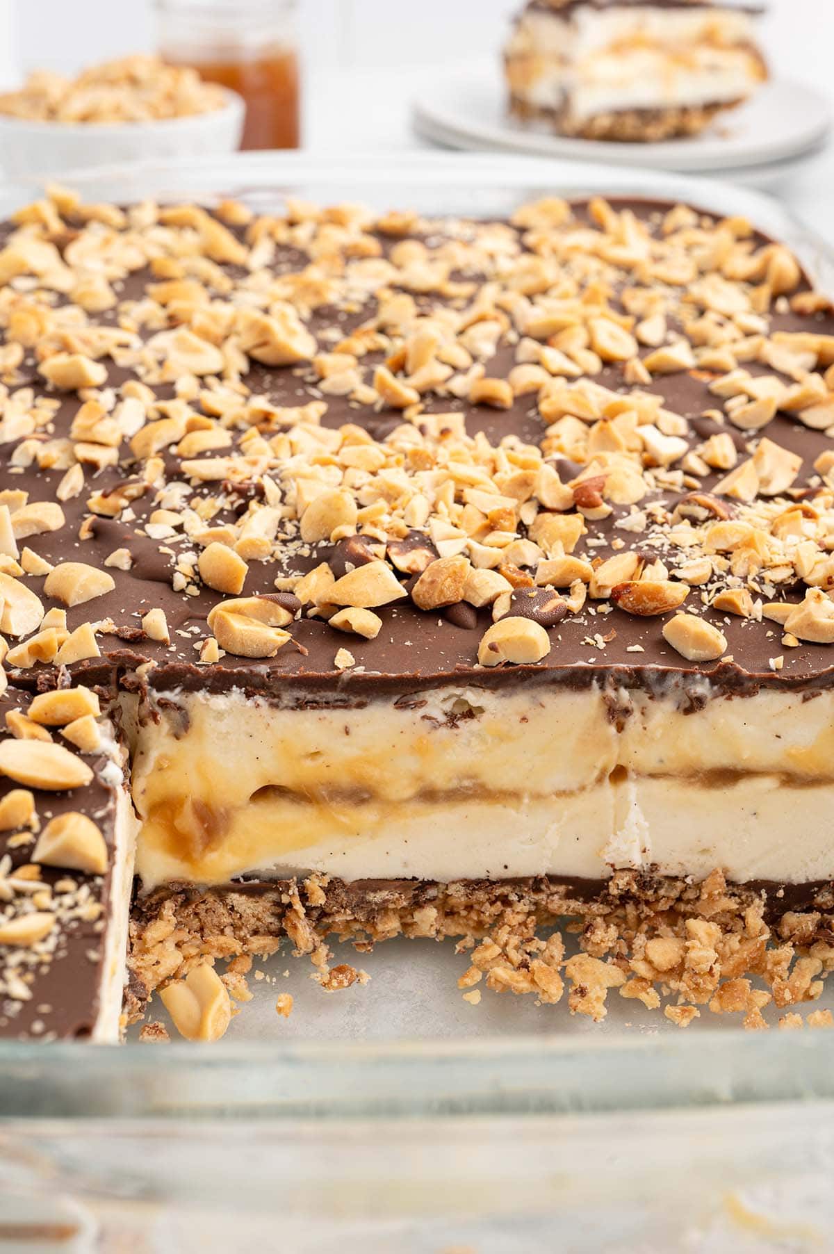 Drumstick Ice Cream Cake in a casserole dish with a few slices cut out.