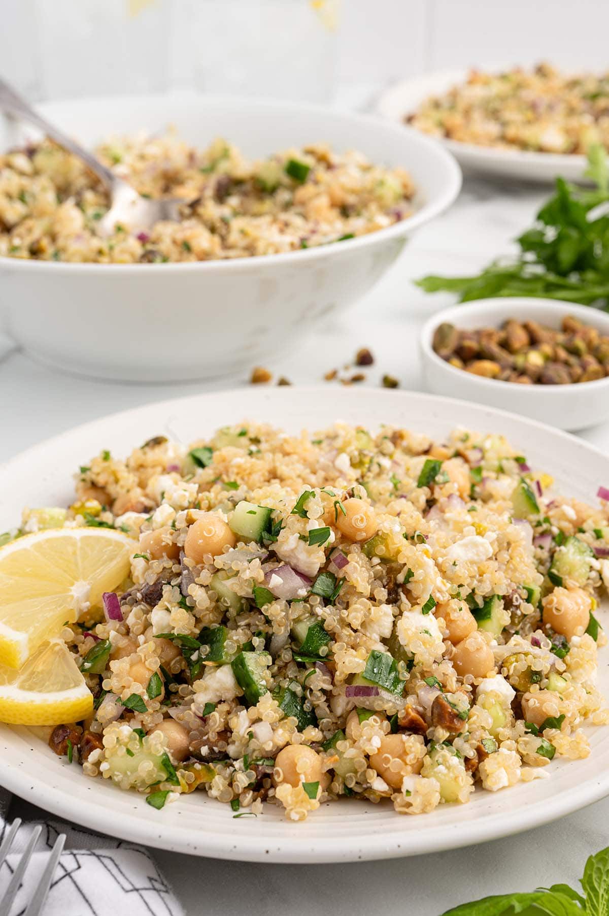 a plate of Jennifer Aniston Salad with lemon wedges on the side.