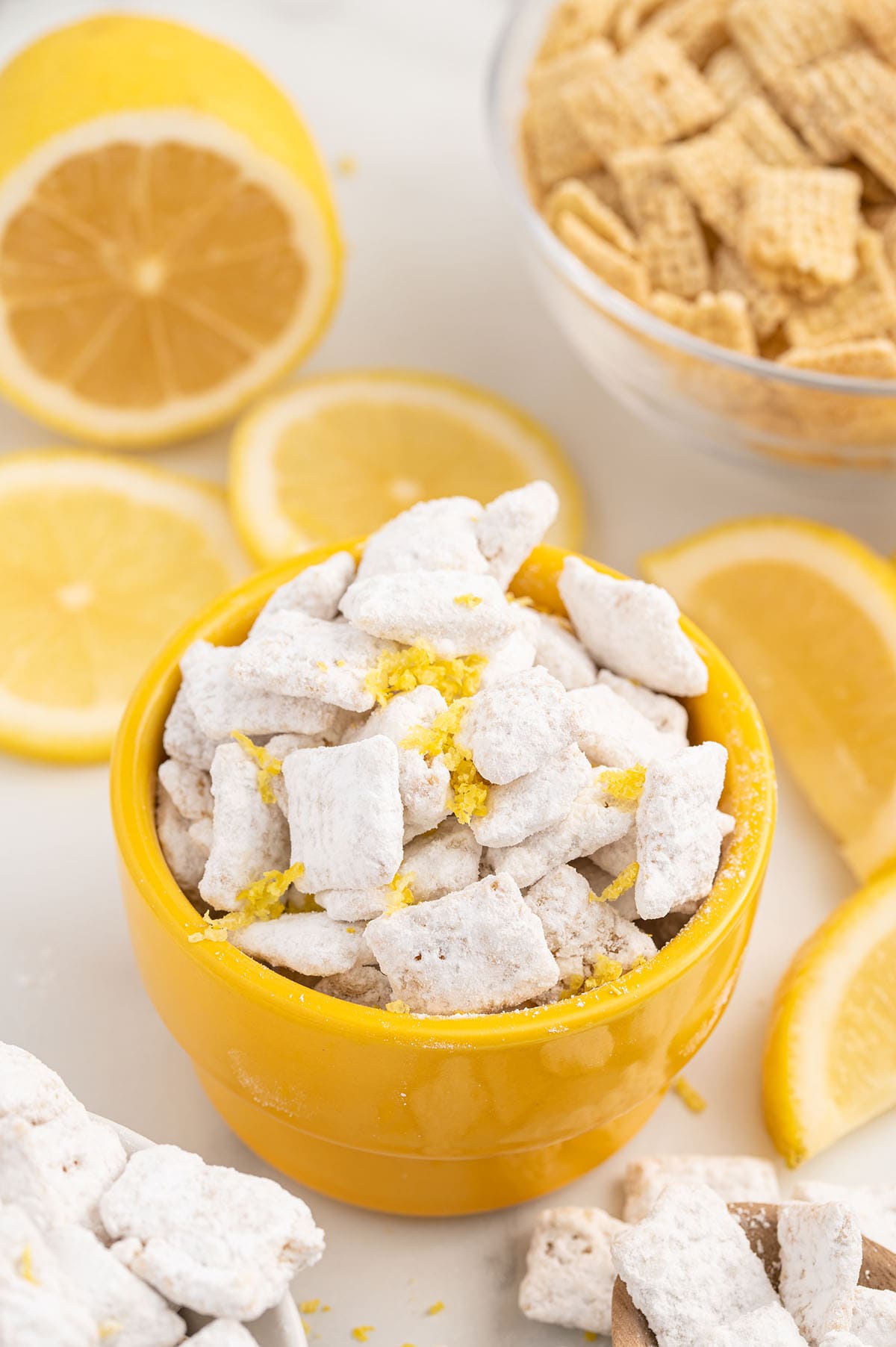 lemon puppy chow served in a yellow bowl. 