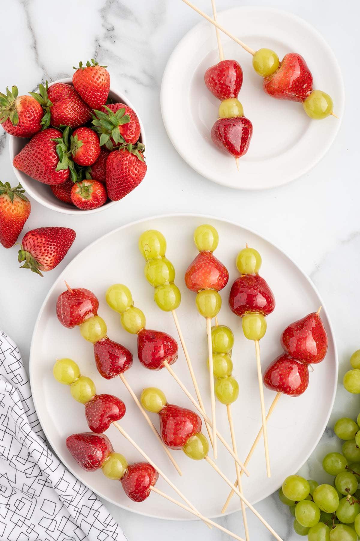 a couple skewers of tanghulu on a plate. 