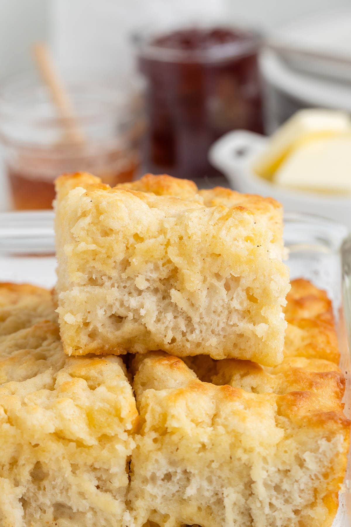 a stack of Butter Swim Biscuits on a baking dish.