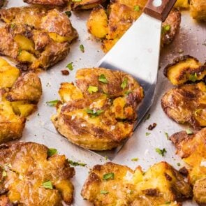 crispy smashed potatoes. on top of baking sheet.