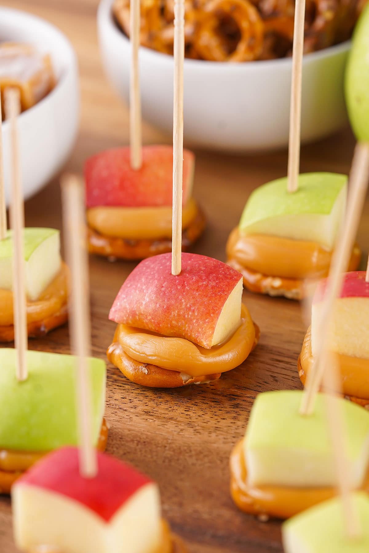 a couple of caramel apple pretzel bites on the table. 