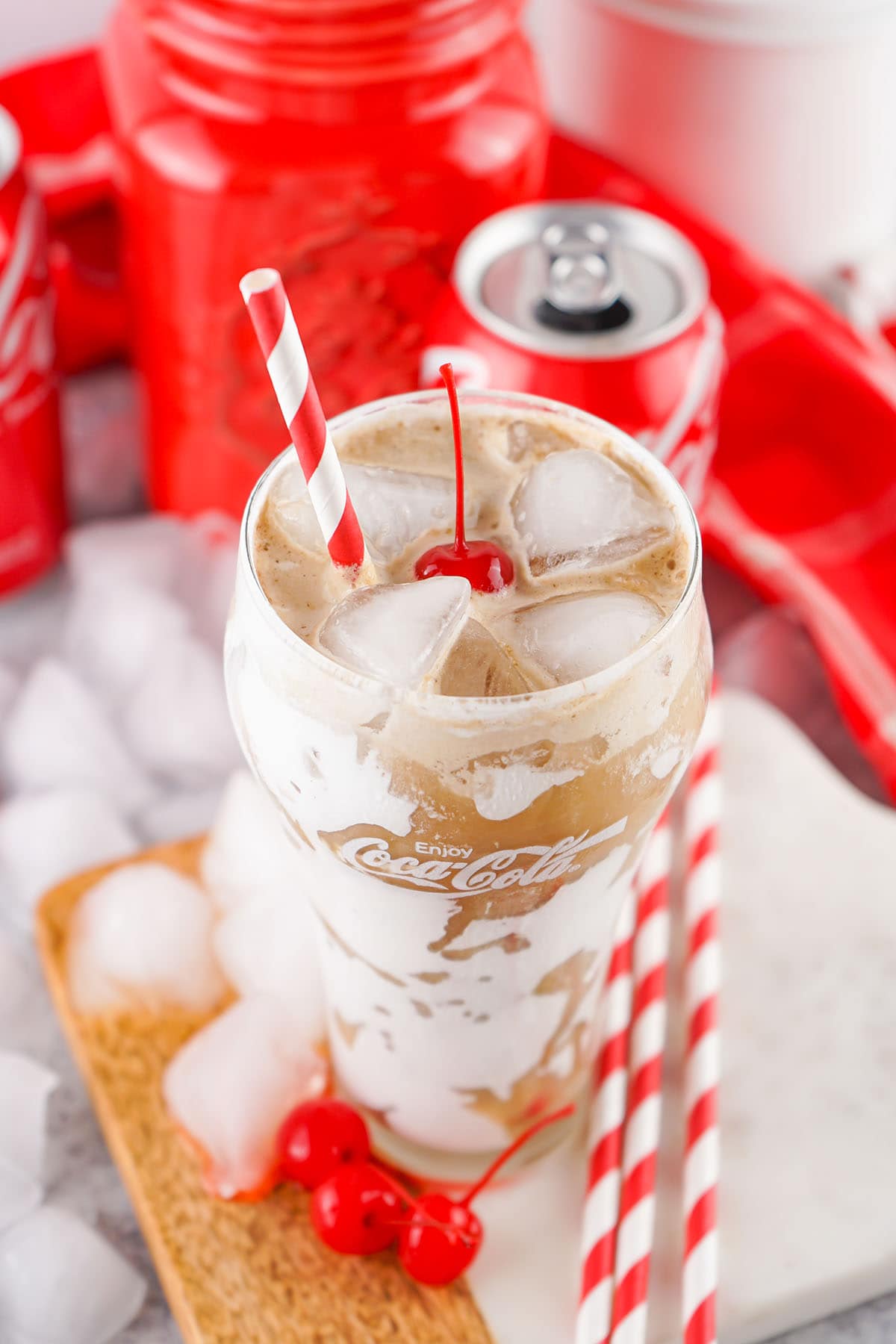 a glass of Fluffy Coke topped with maraschino cherry.