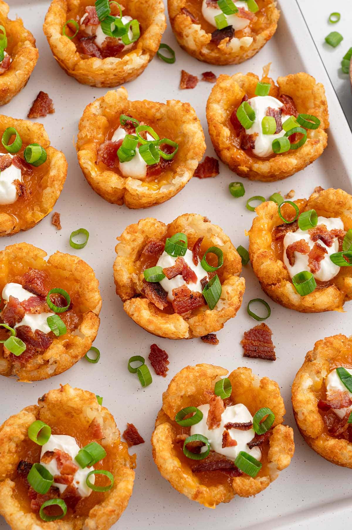 Loaded Tater Tot Cups lined up inside a white tray. 