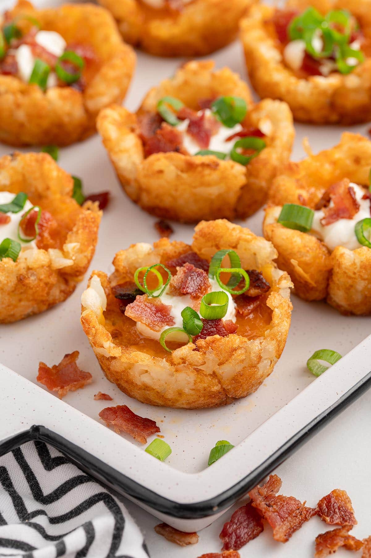 a couple of Loaded Tater Tot Cups topped with bacon. 