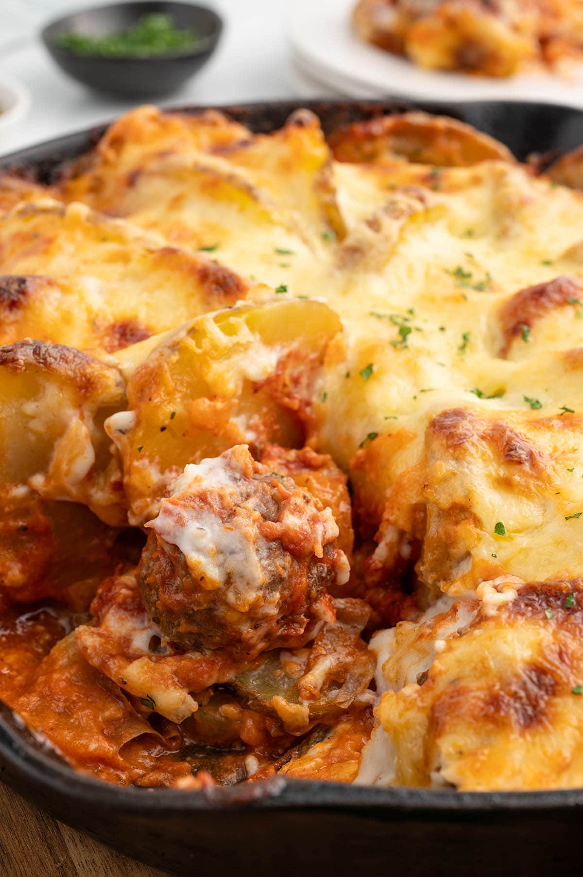 Meatballs and Potatoes in a skillet.