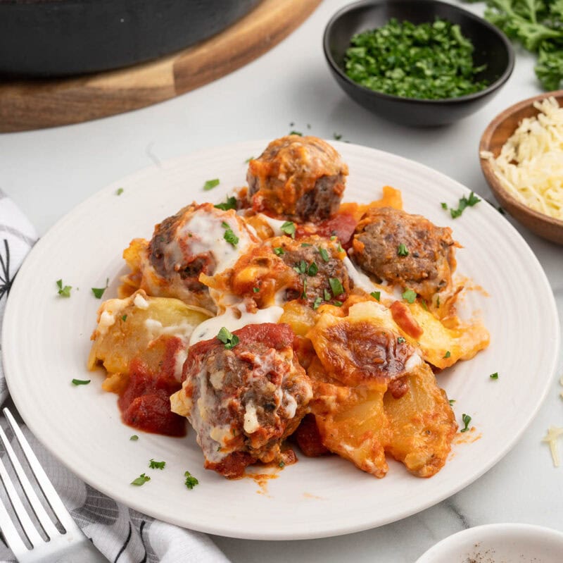 a plate Meatballs and Potatoes garnished with fresh parsley.