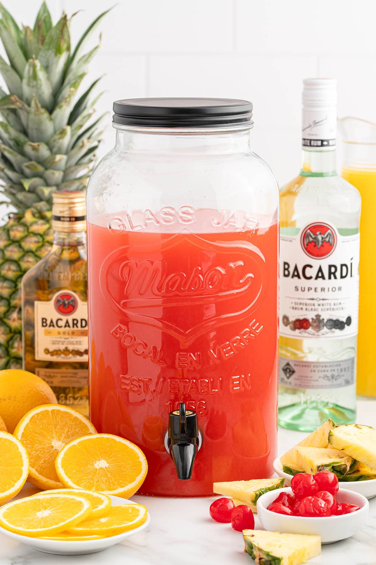 a big glass dispenser filled with Rum Punch.