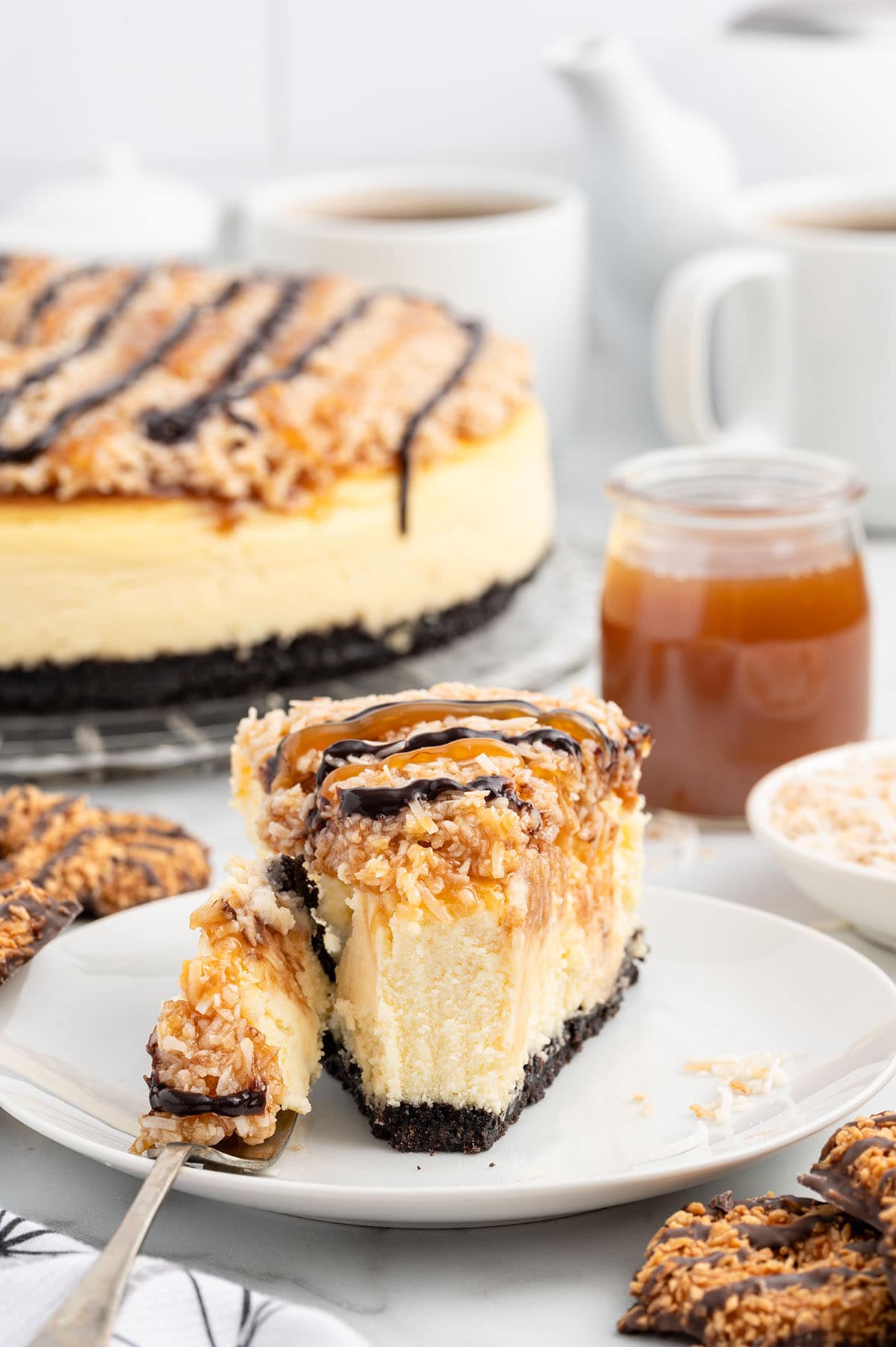 samoa cheesecake served on a white plate. 