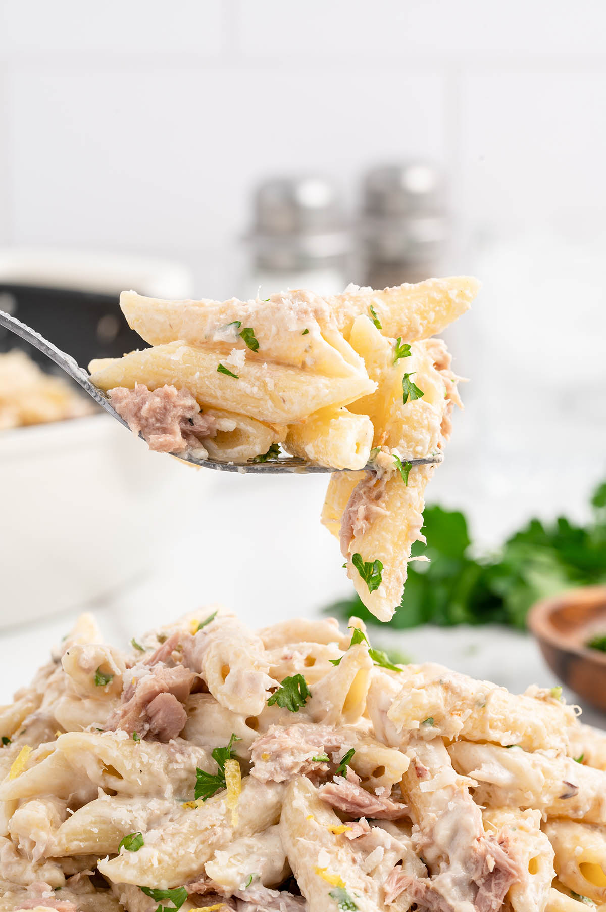 eating tuna pasta with a fork. 