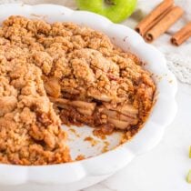 Apple Pie with Graham Cracker Crust in a white pie dish.