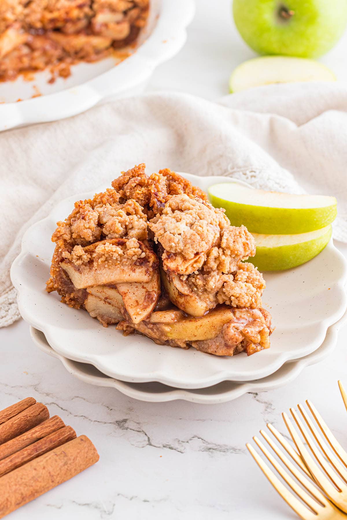 a slice of Apple Pie with Graham Cracker Crust served on a white plate.