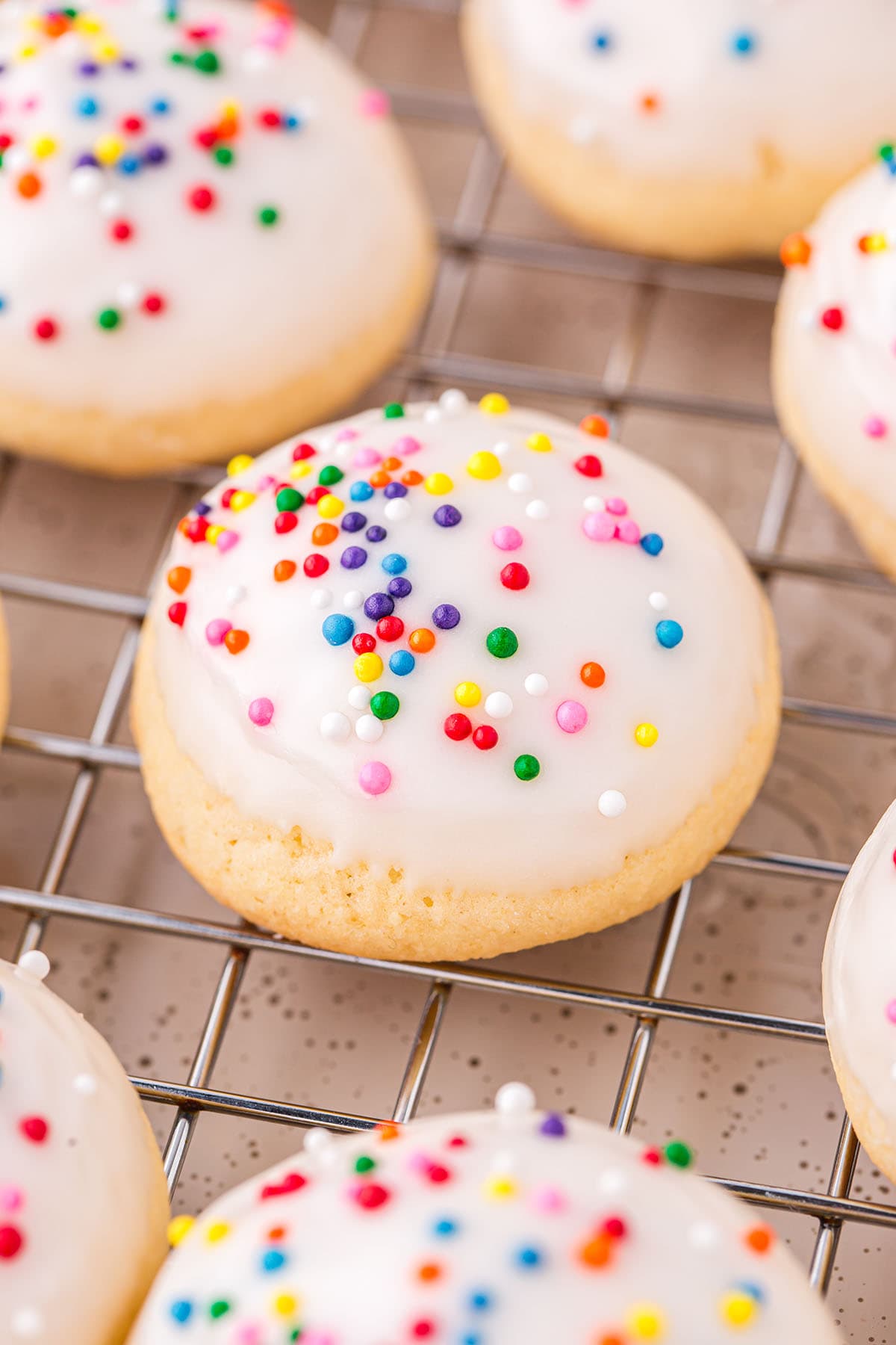 a couple of Italian Wedding Cookies on a cooling rack. 