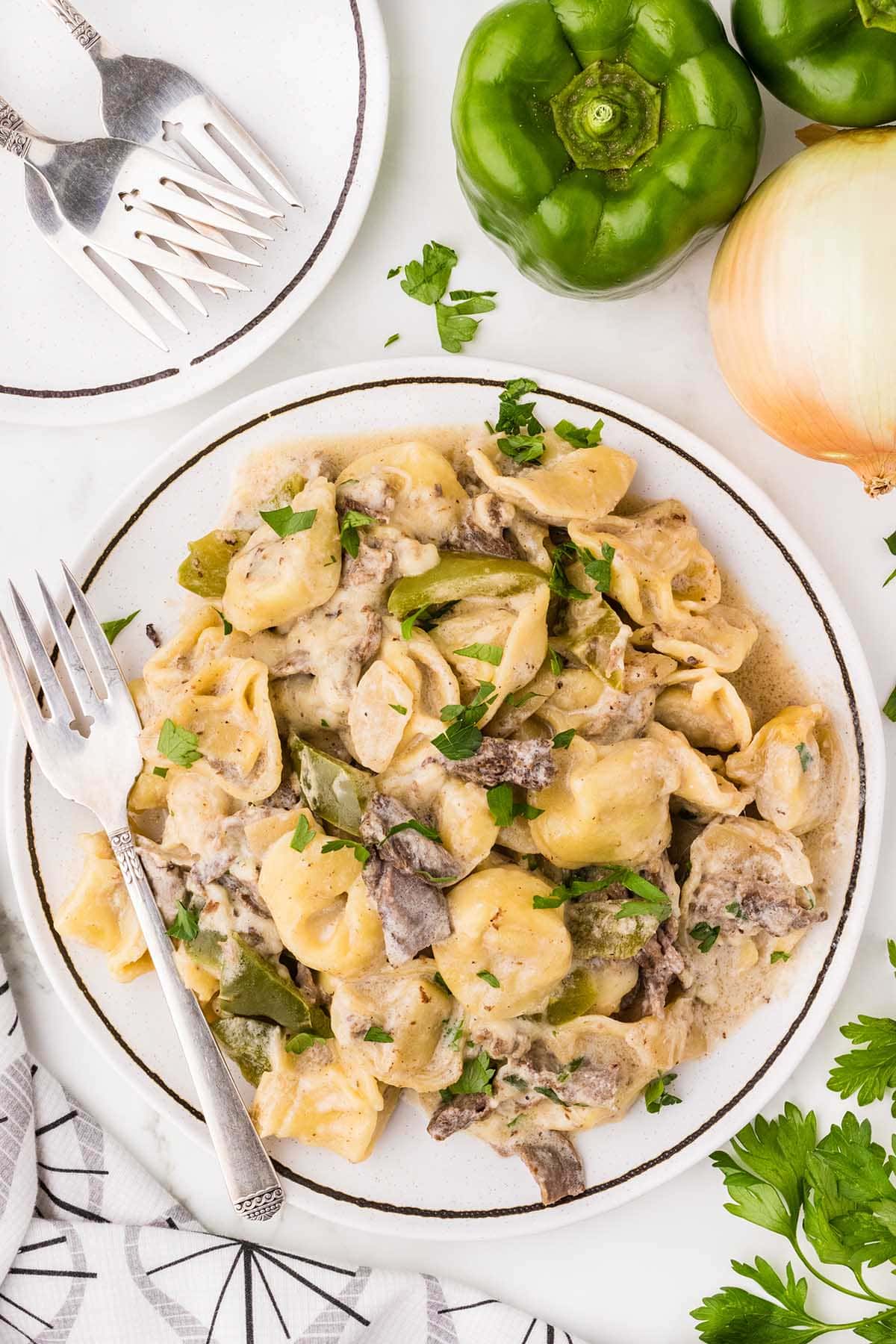 Philly Cheesesteak Tortellini served on a white plate.