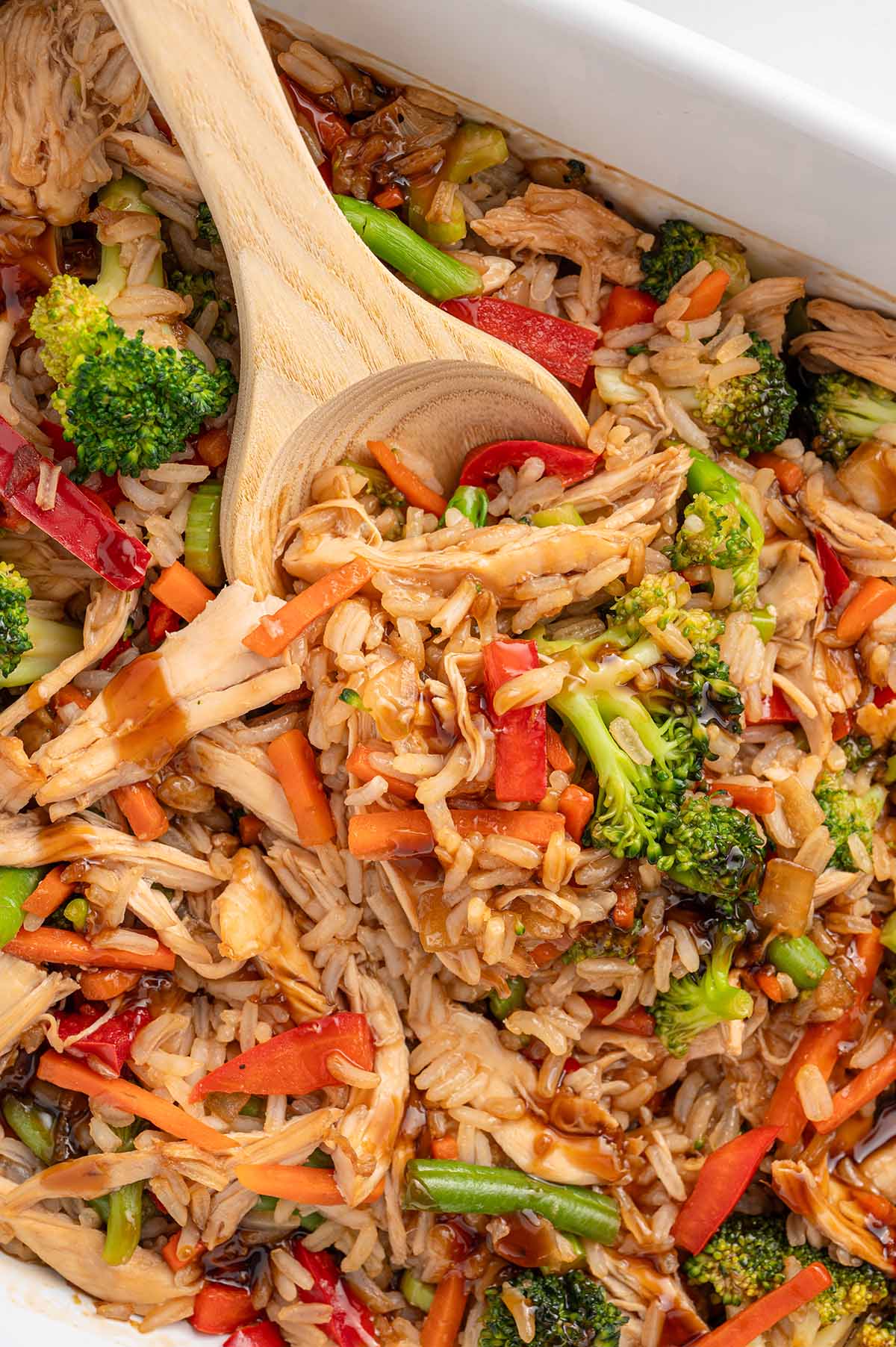 teriyaki chicken with mixed vegetables and rice in a large baking dish.