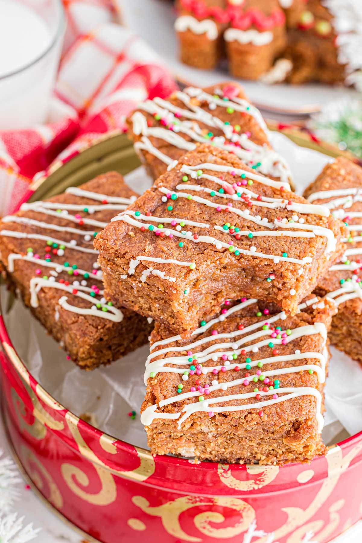 bitten square gingerbread blondies opped with white icing drizzle and colorful sprinkles. 