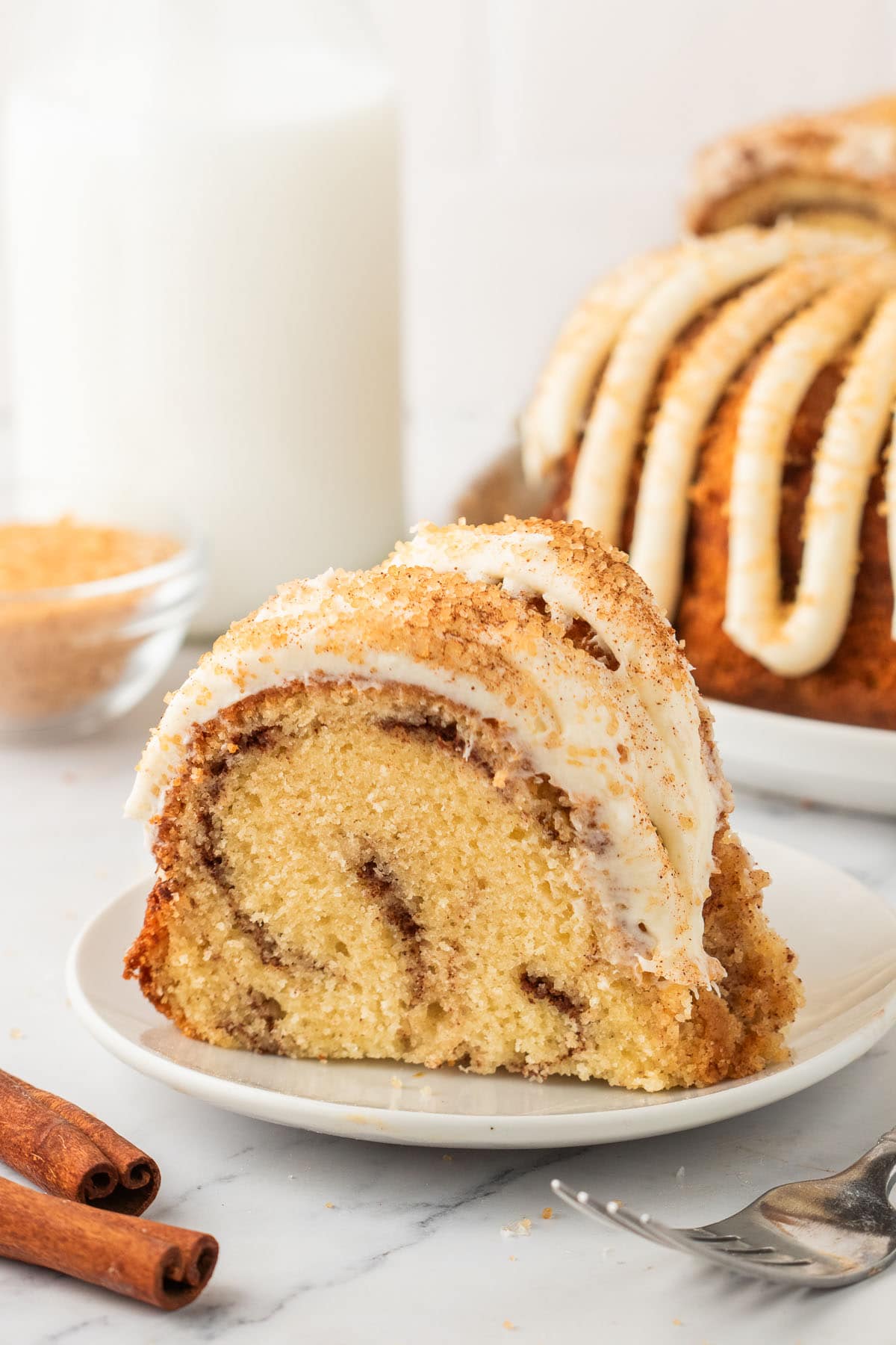 a slice of snickerdoodle bundt cake on a plate. 