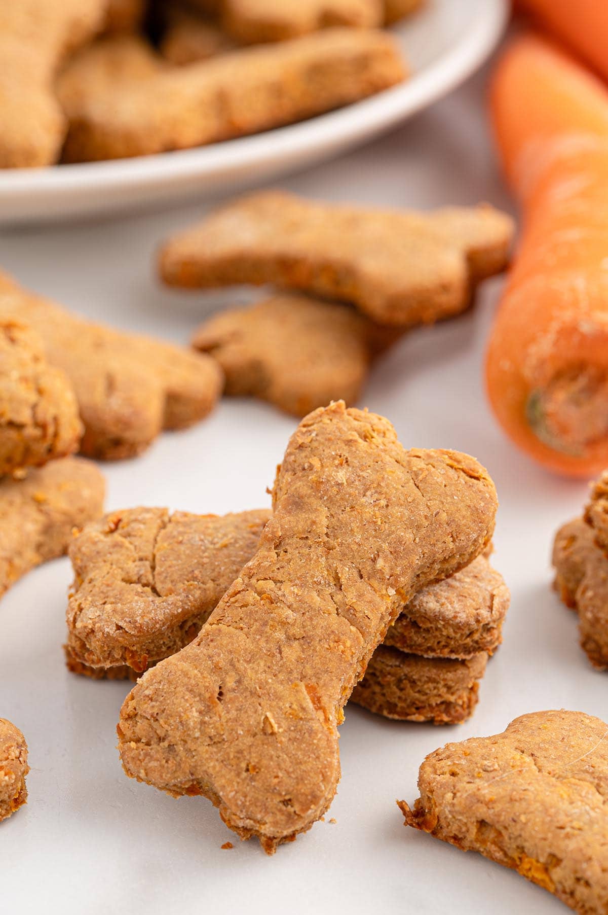 A couple carrot dog treats on the table. 