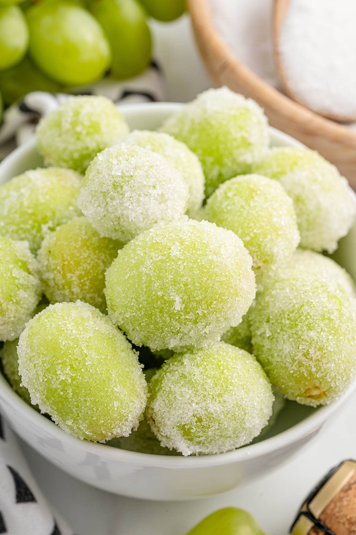 a bowl of Sugared Champagne Grapes on the table.