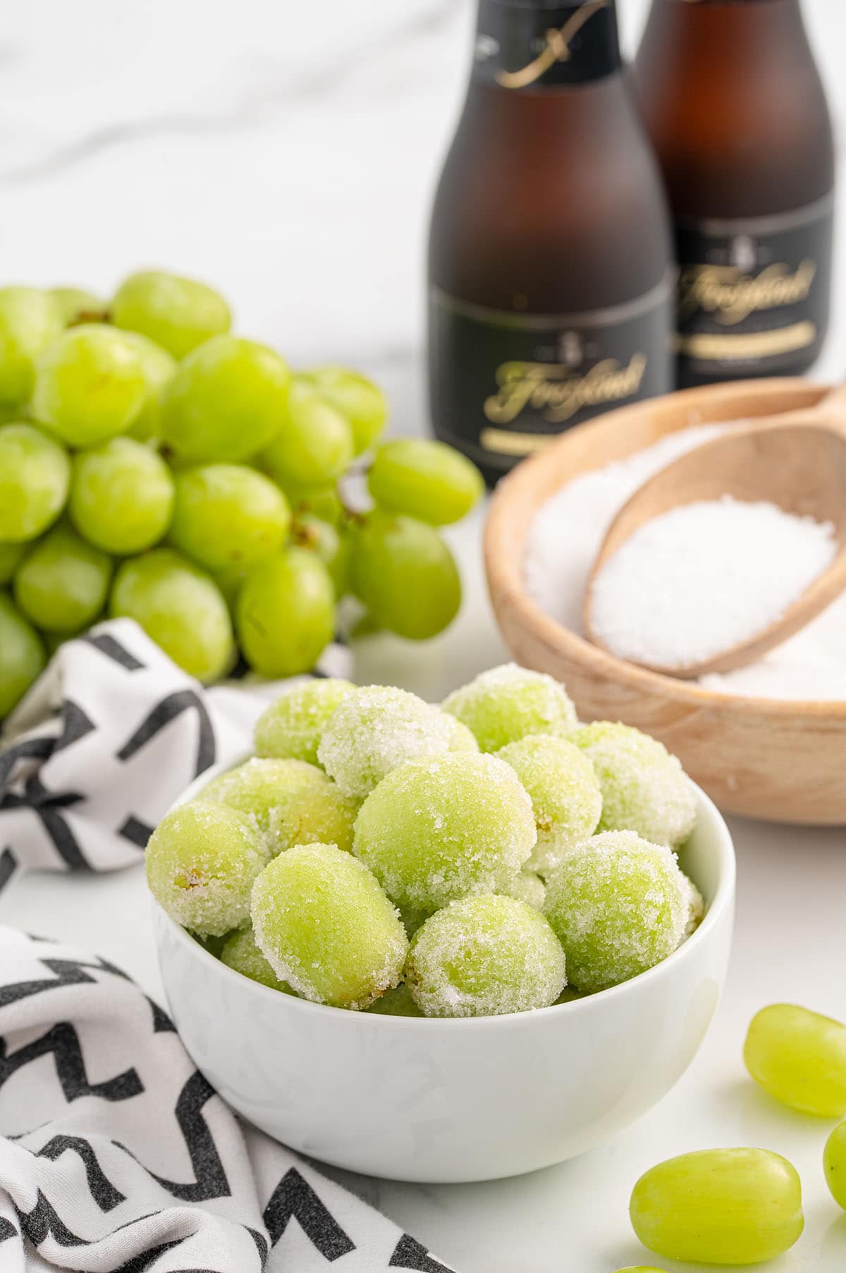 a couple of Sugared Champagne Grapes in a white bowl.