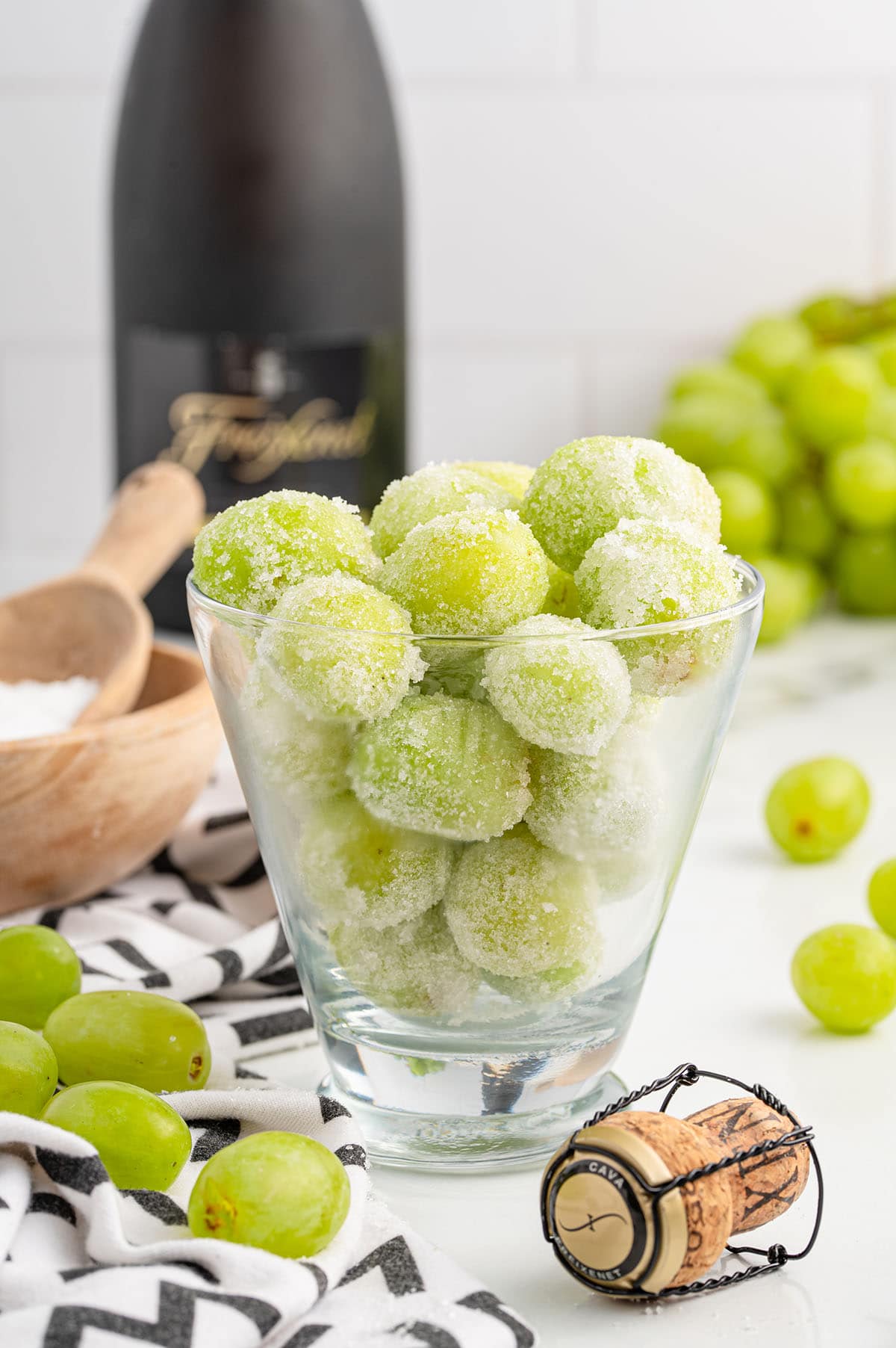 a couple of Sugared Champagne Grapes in a clear glass.