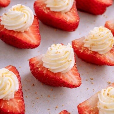 a couple of deviled strawberries with cream cheese on top.