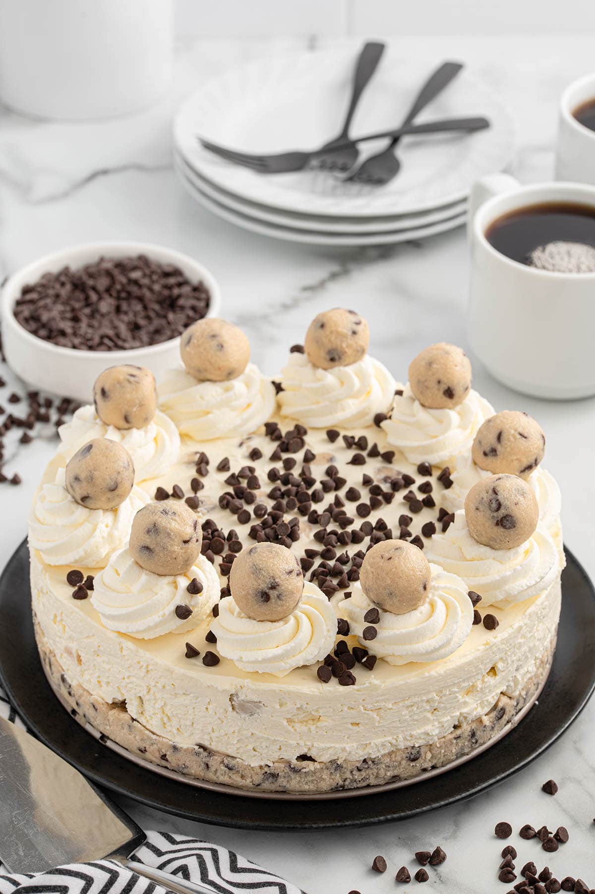 cookie dough cheesecake served on a black plate. 