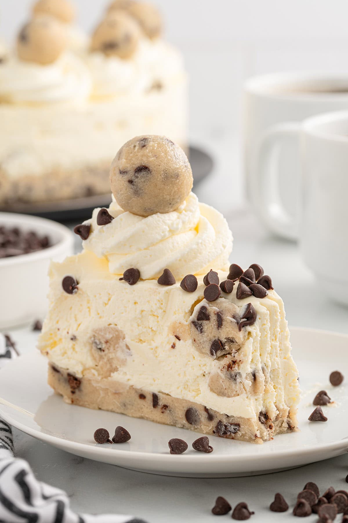 A slice of cookie dough cheesecake on a plate.