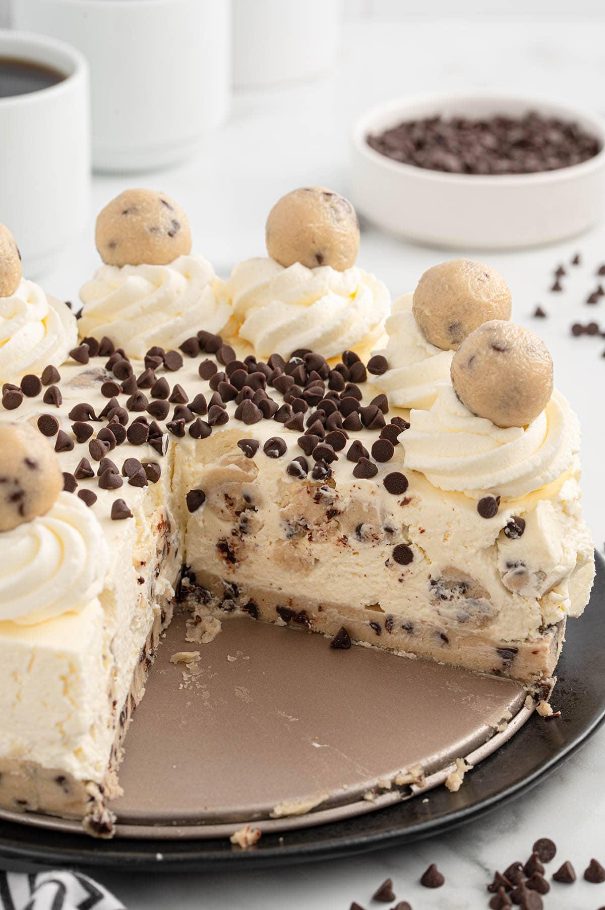 taking out a slice of cookie dough cheesecake.