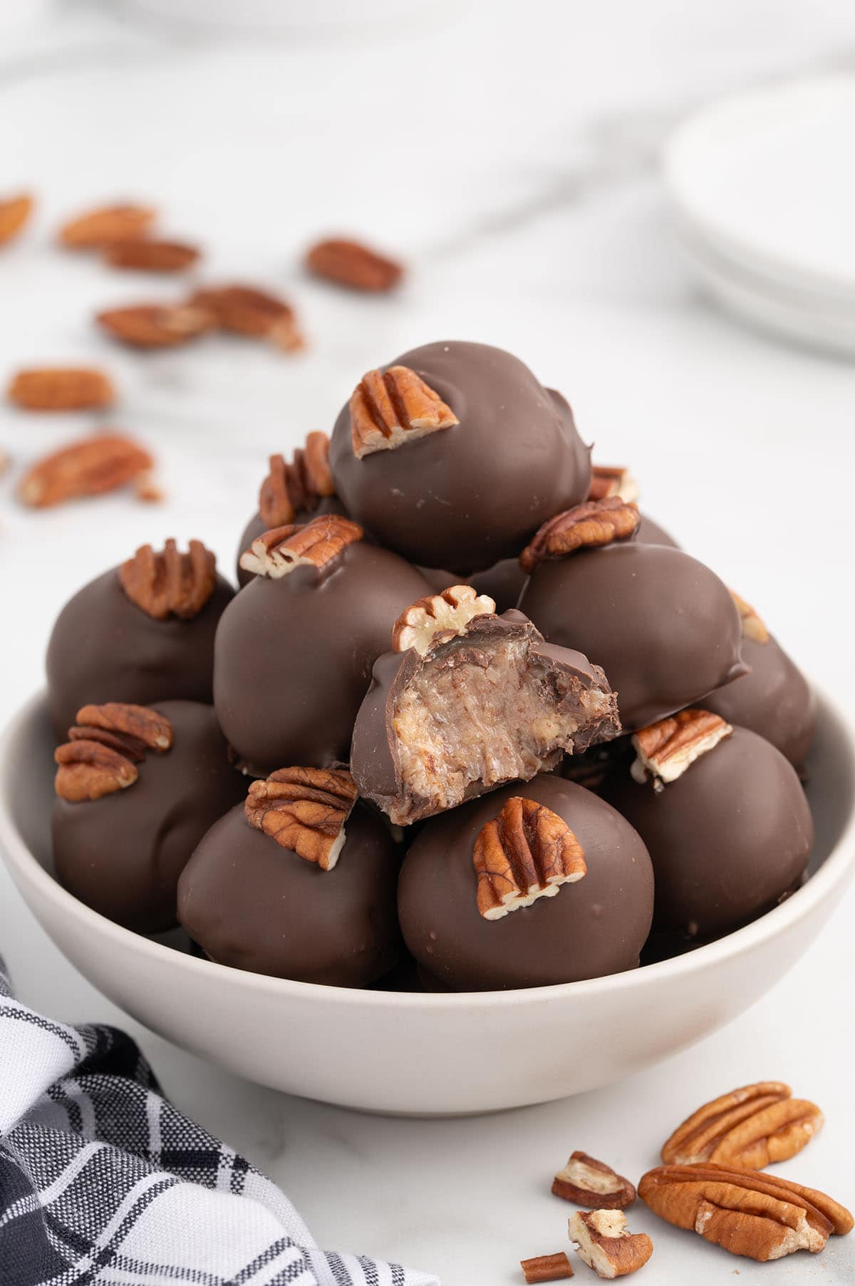 A bowl of chocolate-coated condensed milk pecan balls.